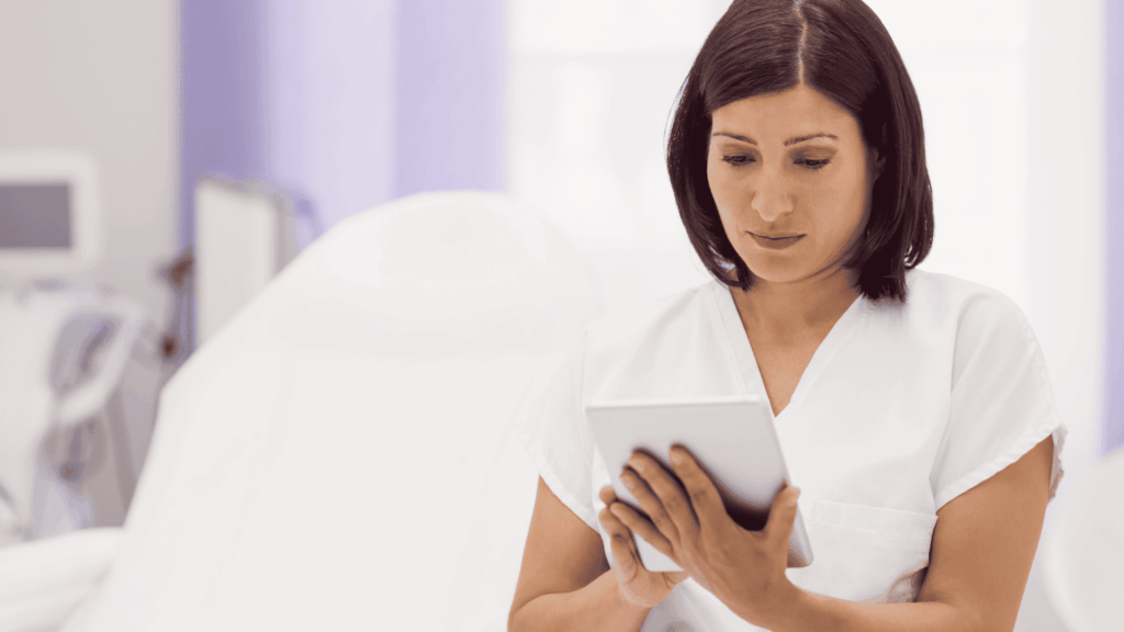 Dermatologist looking at his tablet in his digitalized medical office