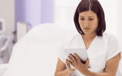 Dermatologist looking at his tablet in his digitalized medical office